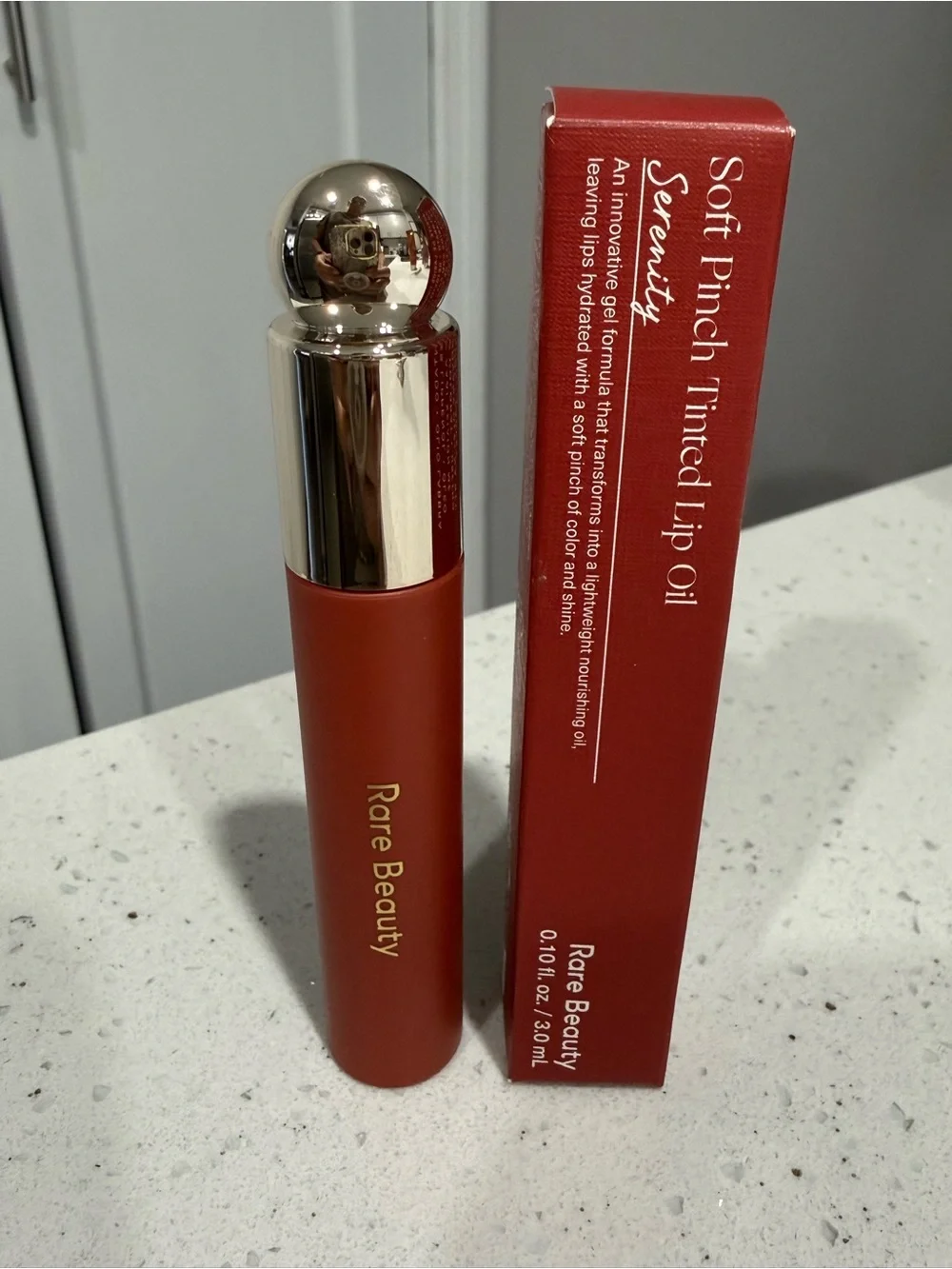 Rare Beauty Soft Pinch Tinted Lip Oil in Deep Coral-Red. Serenity color